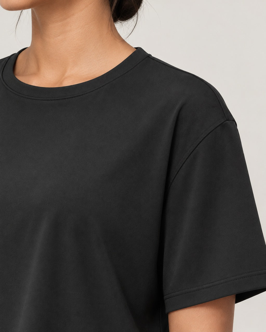 ROMY Ease Cropped Tee in Black — close-up detail
