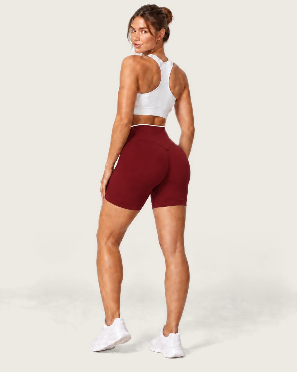 ROMY Form Contrast Waist Shorts in Wine — three-quarter back view