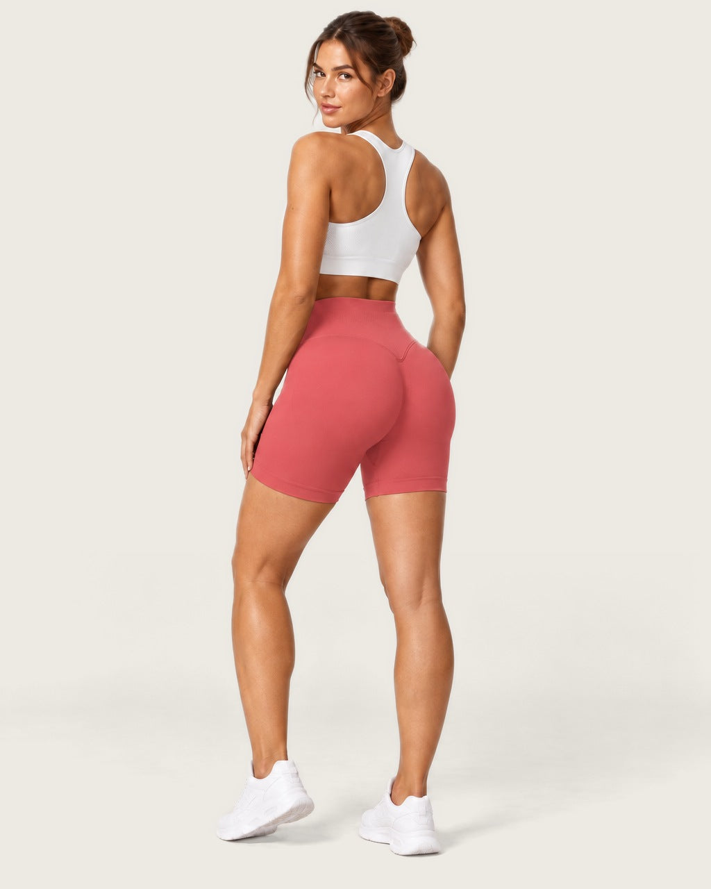 ROMY Form Seamless Shorts in Coral — three-quarter back view