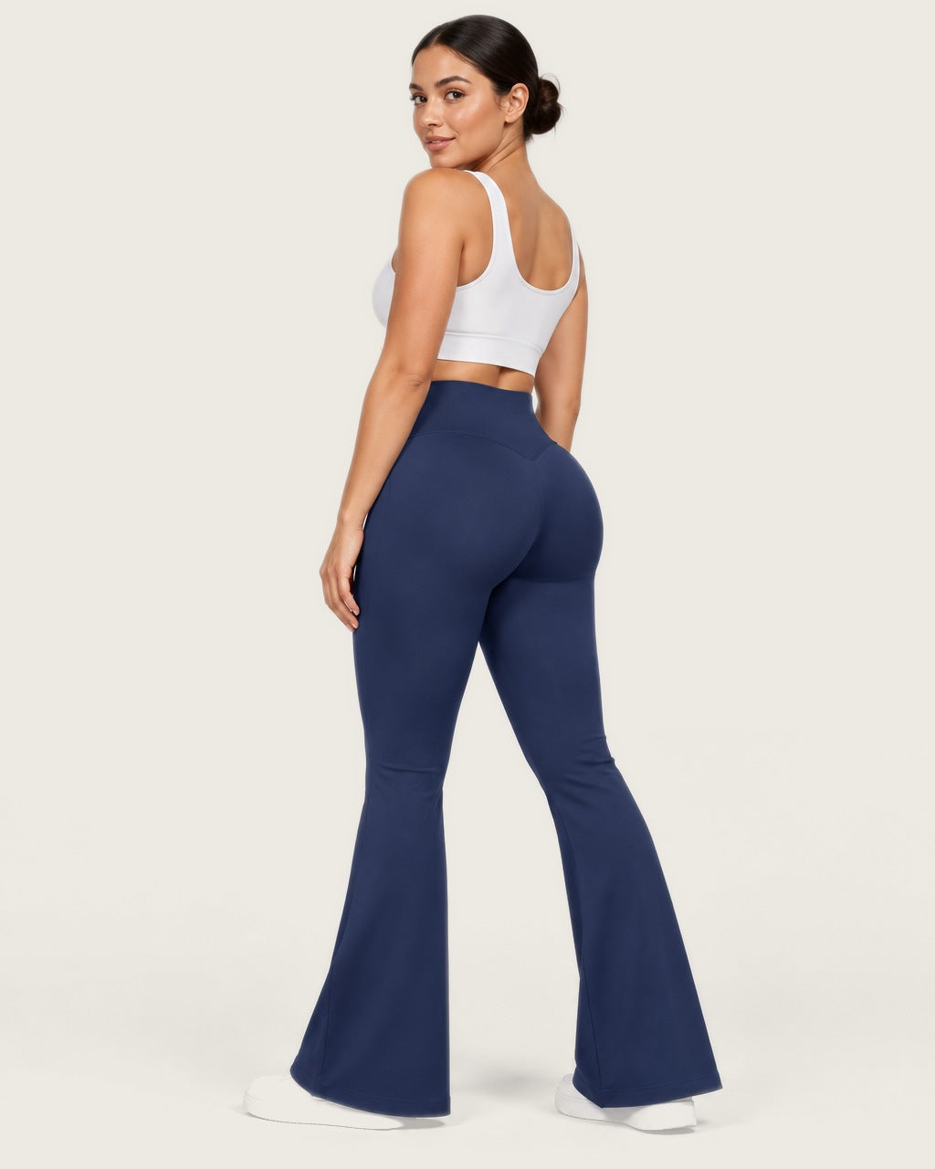 ROMY Sculpt Flare Pant in Navy — three-quarter back view